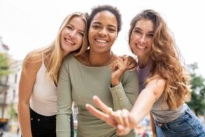 Group of 3 young women laughing